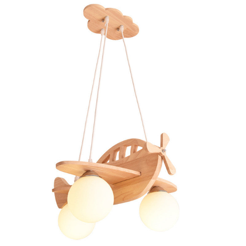 Lustre moderne minimaliste en forme d'avion dans la chambre des enfants